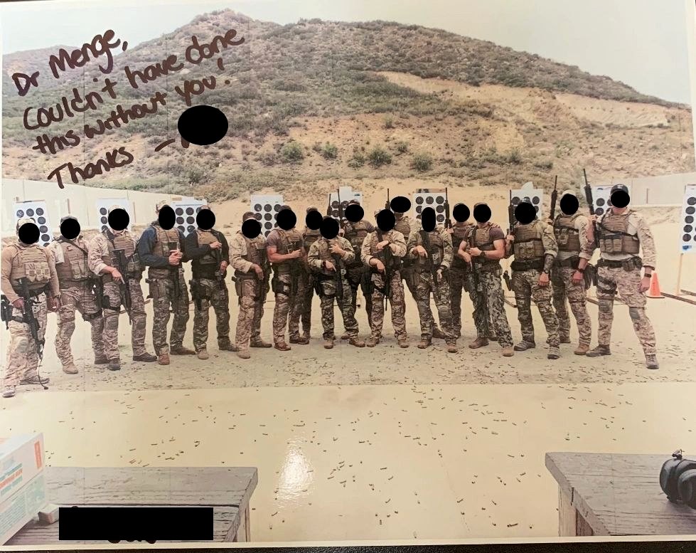 Signed photograph of a military unit assembled on a range, inscribed to Dr. Menge. Faces are obscured in the source photograph.